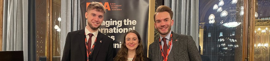 Liverpool Hope University students, Harry Bates, Eimhear Byrne and George Couch, standing with their Outstanding Delegation certificate at the 2023 BISA Model NATO held at the Foreign Commonwealth and Development Office.